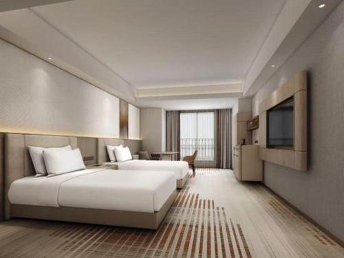 a hotel room with two beds and a flat screen tv at Chengdu Antai Century Hotel in Chengdu