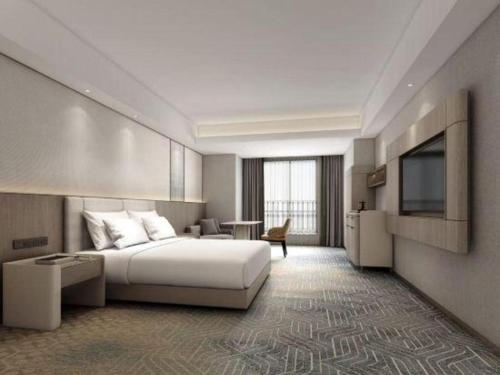 a hotel room with a bed and a television at Chengdu Antai Century Hotel in Chengdu