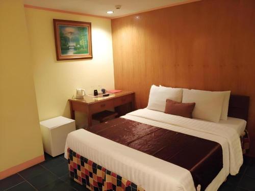Ένα ή περισσότερα κρεβάτια σε δωμάτιο στο Hotel Asuncion