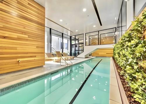 an indoor swimming pool in a house at High-Floor 2BR Apartment Near Sky Tower Pool Gym in Auckland