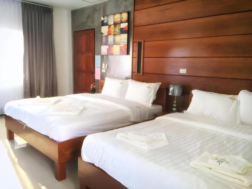 two beds sitting next to each other in a bedroom at The Key Hotel in Ko Lipe