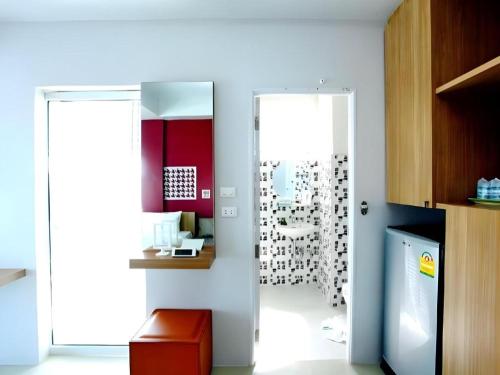 a kitchen with a door leading into a room with at Tonkok Hotel in Chiang Rai