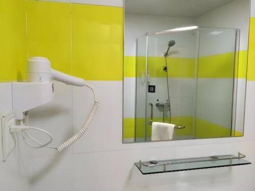 a bathroom with a shower and a mirror at 7 Days Inn Nanjing Gaochun Metro Station in Gaochun