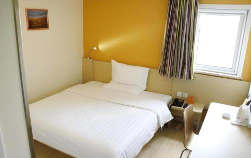 a small room with a bed and a window at 7 Days Inn Chengdu North Railway Metro Station in Chengdu