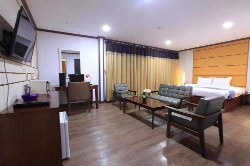 a hotel room with a bed and a living room at Horizon Hotel in Olongapo