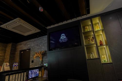 a room with a tv on a wall with shelves at NB HOTEL in Johor Bahru