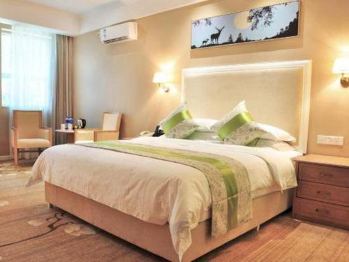 a bedroom with a large bed in a room at Catic Hotel--Adjacent Buliding in Zhuhai