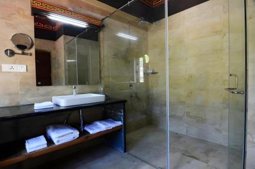 a bathroom with a sink and a shower at Hotel Valley Thimphu in Thimphu