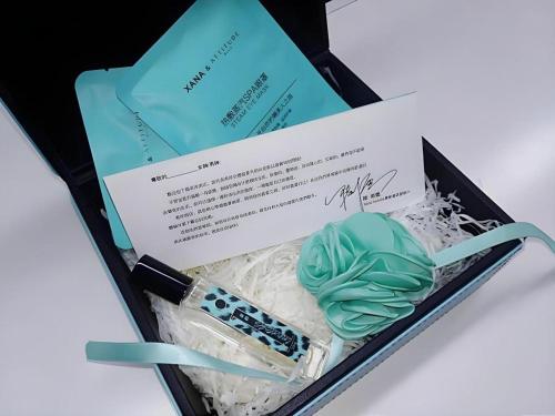 a gift box with a certificate and a thermometer at Xana Hotelle·Ji'nan Hi-tech Zone Century Avenue Tangye in Jinan