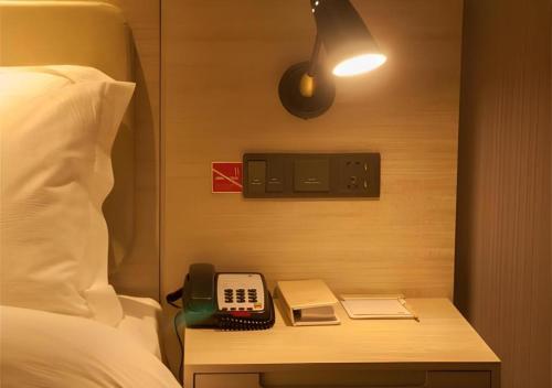 Ένα ή περισσότερα κρεβάτια σε δωμάτιο στο Echarm Hotel Binzhou Boxing Yinzuo