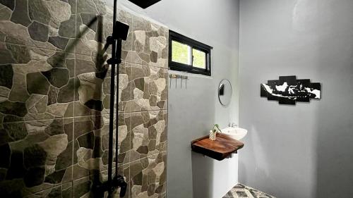 a bathroom with a shower with a toilet and a sink at AK's Surf Resort in Wainapal