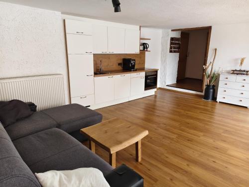a living room with a couch and a table at Ferienwohnung Haiberg in Rudolfing