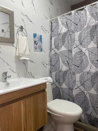 a bathroom with a toilet and a shower curtain at Cozy Home In Magical Salento in Salento