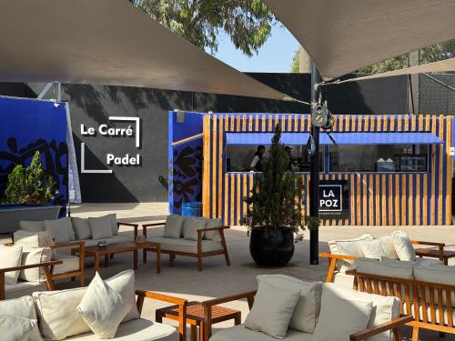 a pavilion with tables and chairs and a food stand at Odyssee Park Hotel in Agadir