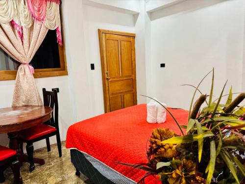 a room with a bed and a table and a window at Casa Don 20 in San Marcos La Laguna
