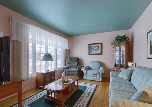a living room with a couch and a table at Private roomC Fee parking 15min downtown in Longueuil