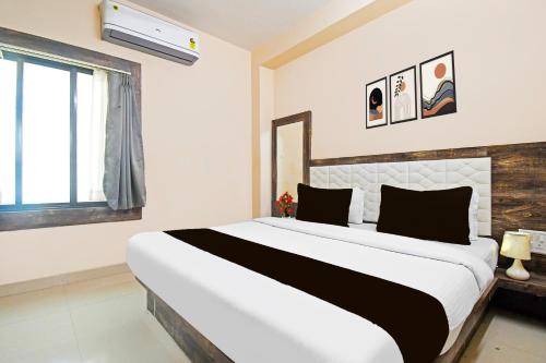a bedroom with a large bed and a window at Super Collection O Gandhi Ghat Formerly Sai Resorts in Puri