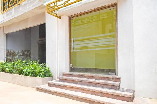 a glass door of a building with stairs in front at Super Collection O Gandhi Ghat Formerly Sai Resorts in Puri