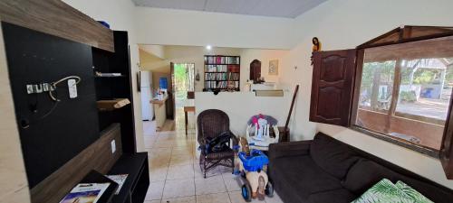 a living room with a couch and a window at Casa de Praia Guajarino - COP 30 in Barcarena