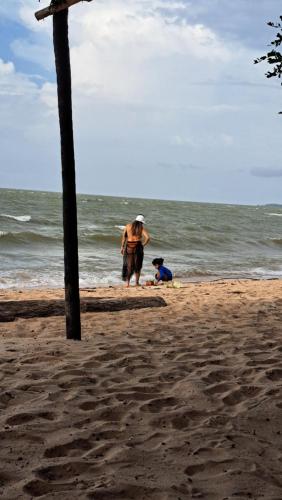 a man and a dog on the beach at Casa de Praia Guajarino - COP 30 in Barcarena