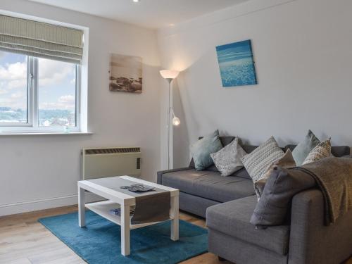 a living room with a couch and a table at Coast Apartment in Whitby