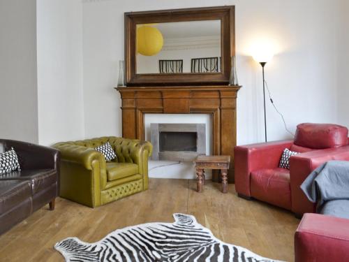 a living room with a fireplace and a mirror at The Town House in Scarborough