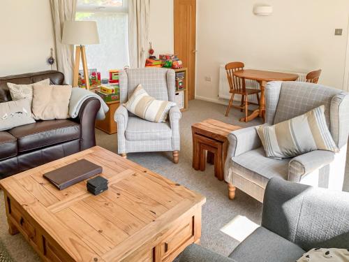 a living room with two couches and a coffee table at September Cottage in Brancaster