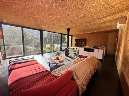 a living room with a large bed and a table at The View House Warburton in Warburton