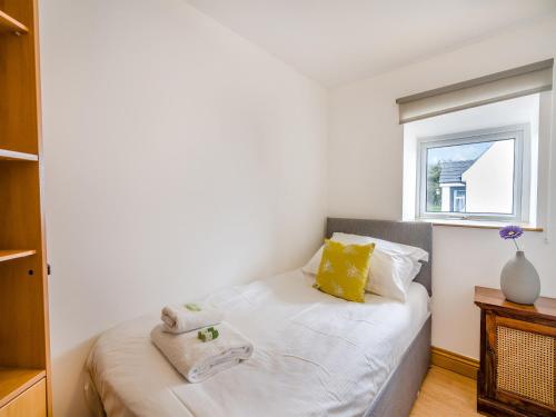 a bedroom with a bed with towels on it at Ben Ma Cree in Portpatrick