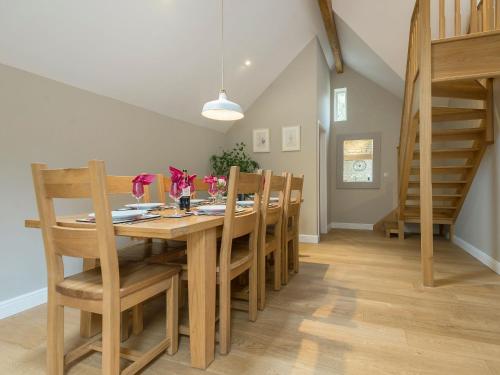 a dining room with a wooden table and chairs at The Stables in Heydour