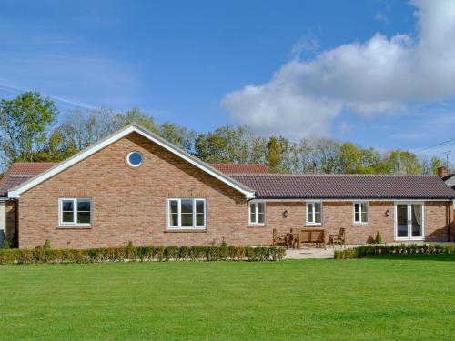 a large brick house with a large yard at The Old Bull Pen in Appleshaw