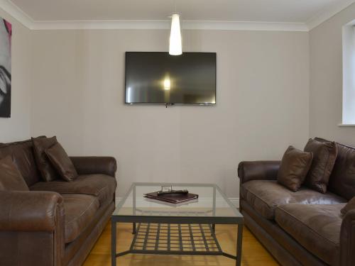 a living room with two couches and a glass table at Hollies Cottage 10- Ukc4536 in Martock