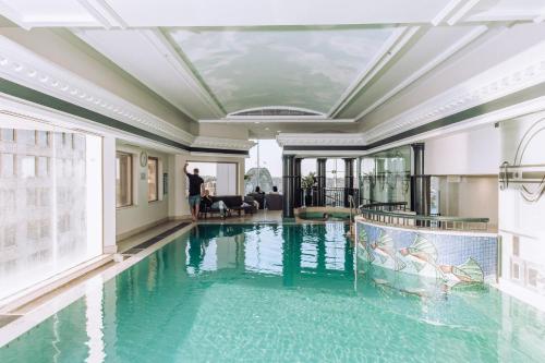 a large swimming pool in a building with a ceiling at Spectacular Suite, Bridge & Water views, The Rocks in Sydney