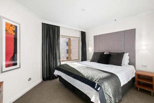 a bedroom with a large bed and a window at Spectacular Suite, Bridge & Water views, The Rocks in Sydney