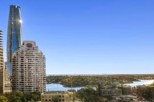 a view of a city skyline with a tall skyscraper at Spectacular Suite, Bridge & Water views, The Rocks in Sydney