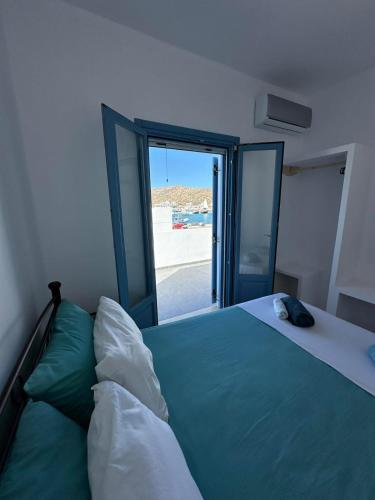 a bedroom with a bed with a view of the beach at #9 Lipsi Port Apartment - Gerani No#9 in Lipsoi
