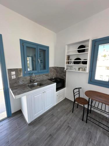a kitchen with a sink and a table at #9 Lipsi Port Apartment - Gerani No#9 in Lipsoi