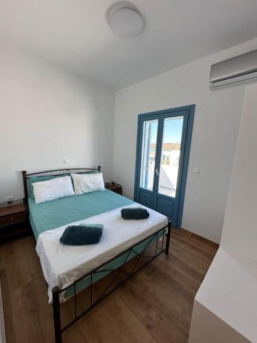 a bedroom with a bed with two pillows on it at #9 Lipsi Port Apartment - Gerani No#9 in Lipsoi