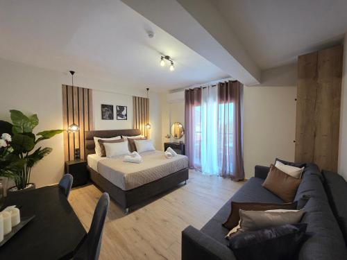 a living room with a bed and a couch and a bed and a living room at Athenee in Preveza