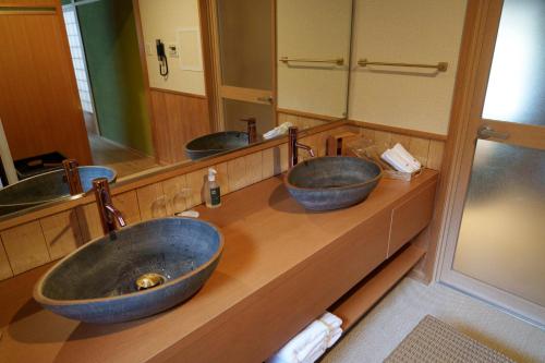 a bathroom with three sinks and two mirrors at 洗心和方 Senshin Waho in Awaji