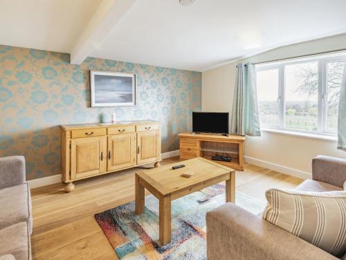 a living room with a tv and a table at Country View - Uk38223 in Ashby cum Fenby