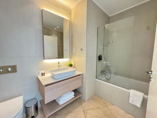 a bathroom with a sink and a shower at SkyHigh Park View Residence in Nicosia