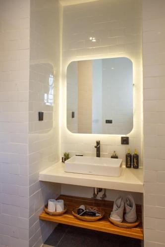 a bathroom with a white sink and a mirror at Jaya Villas #1 in Uluwatu