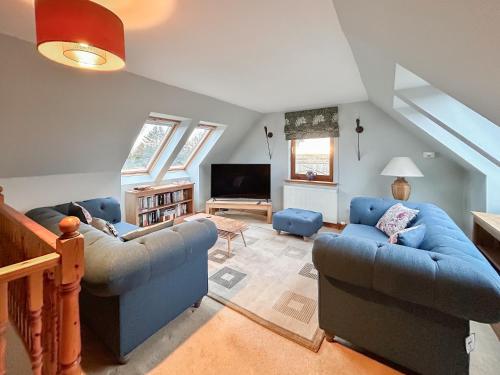 a living room with two couches and a tv at Sheildaig Cottage Annex in Laurencekirk