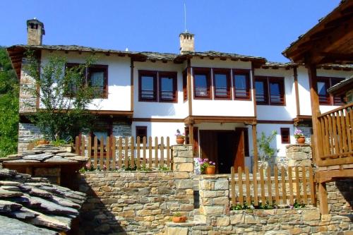 a house with a wooden fence in front of it at Complex Kosovo Houses in Kosovo