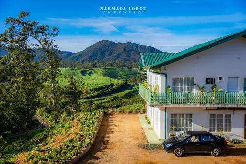 a house with a car parked in front of it at Ambewela Narmada lodge in Nuwara Eliya