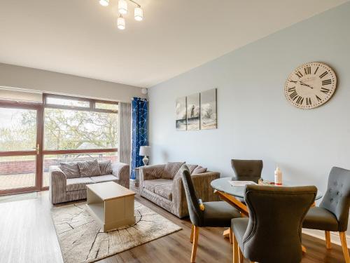a living room with a clock on the wall at Cottage 8 - Uk38219 in Ashby cum Fenby