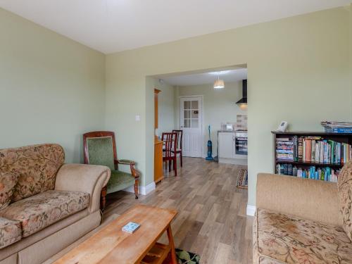 a living room with a couch and a table at Potting Shed - Uk48564 