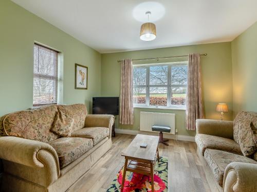 a living room with two couches and a tv at Potting Shed - Uk48564 