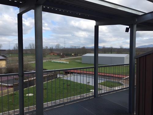 a balcony with a view of a soccer field at Ferien- Und Winzerhof Simon in Freiburg im Breisgau